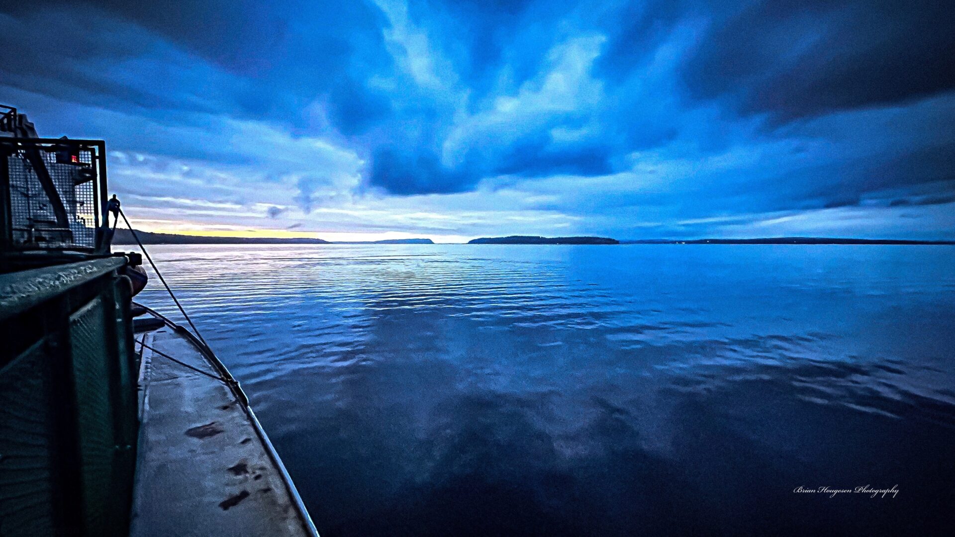 A boat is in the water under a cloudy sky.