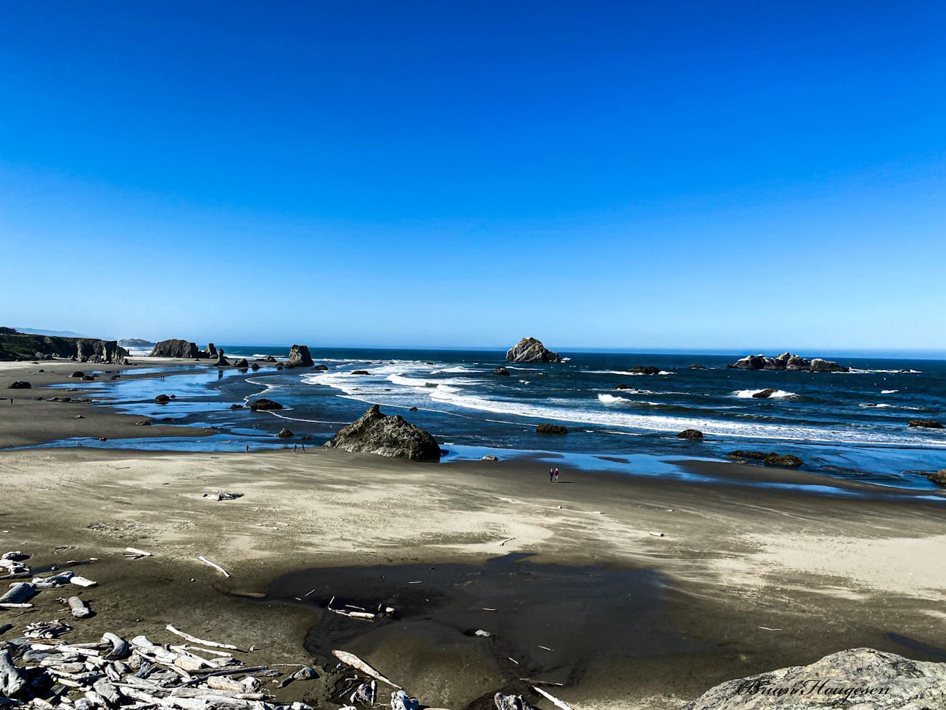 A beach with rocks and water on it