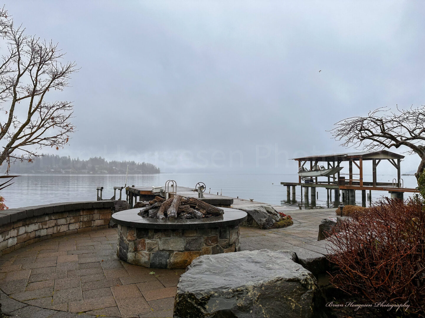 A fire pit sitting next to the water.