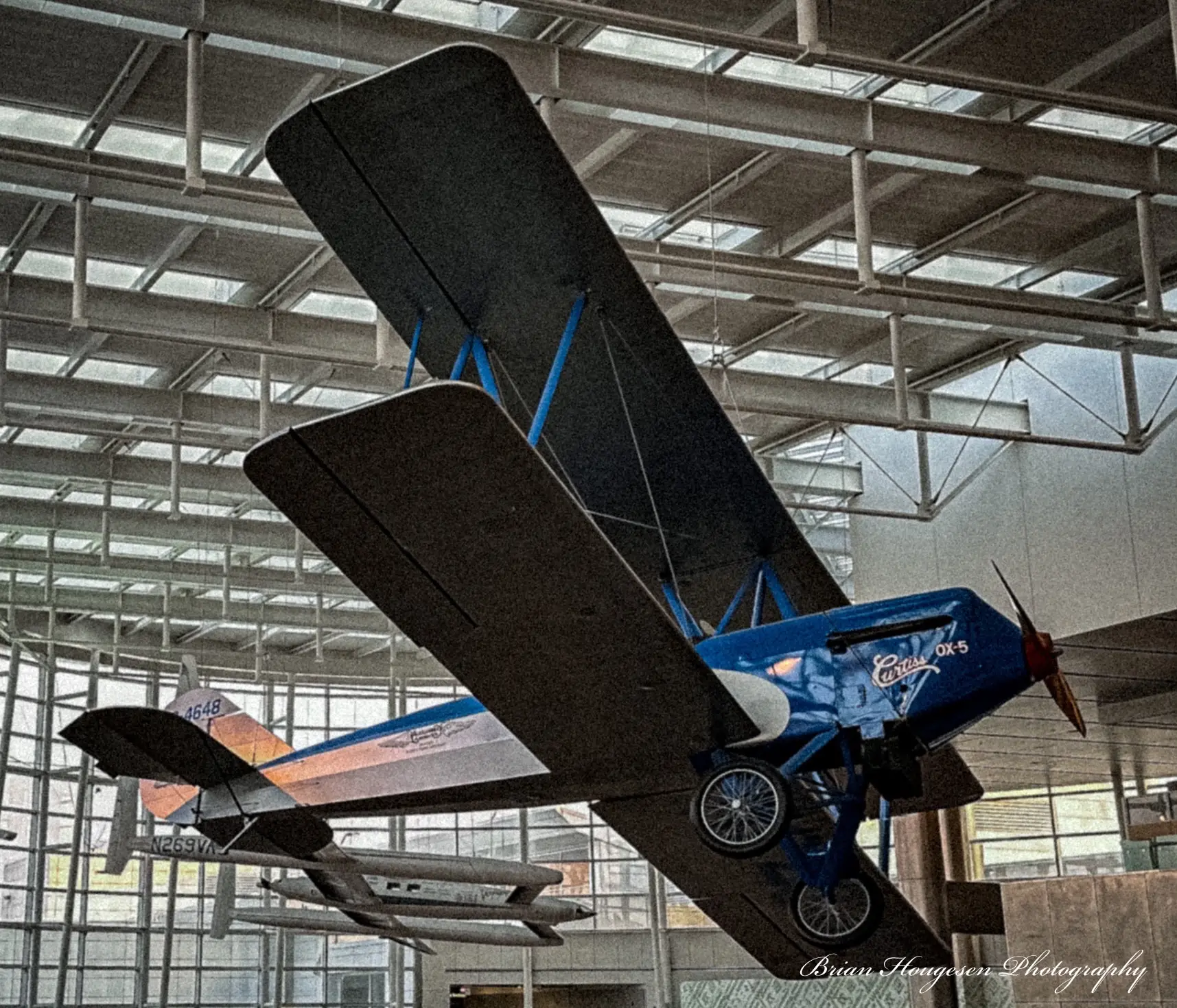 A blue airplane is in the air hangar.